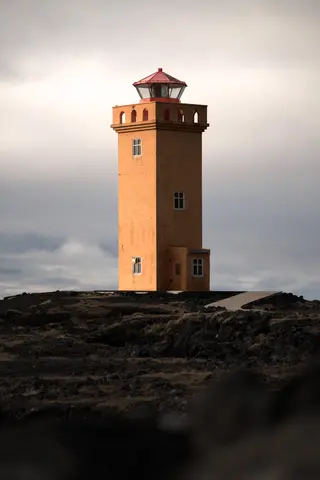Svörtuloft lighthouse on the coast of Iceland under a dramatic sky.