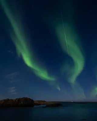 Northern lights over Atlantic Ocean at Borgarnes, Iceland.